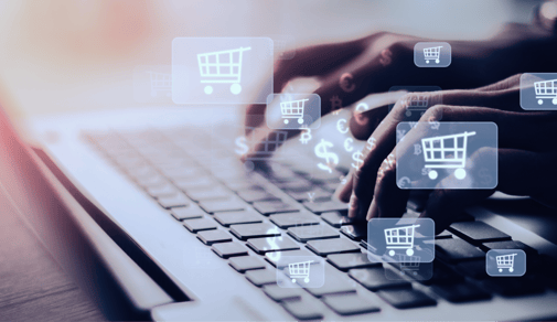 Online shopping concept with hands typing on a laptop and shopping cart icons.