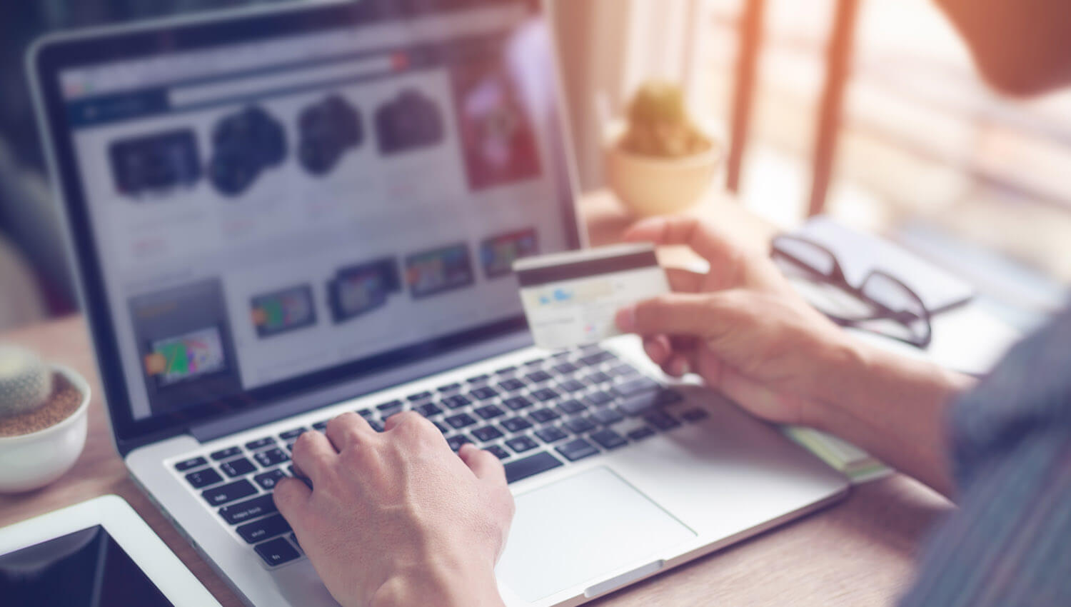 An example of functional testing of a retail transaction on a website. Lifestyle image showing a laptop displaying a transaction screen. A male
