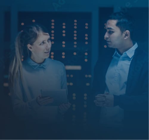 Man and woman discussing inside tech building