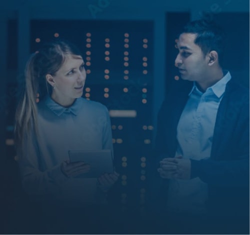 Man and woman discussing inside tech building