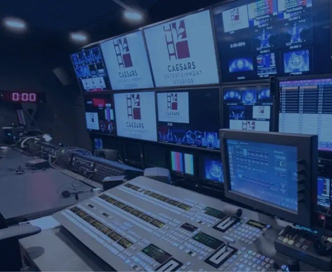 Computers and tech equipment with Caesars logo and various data shown on screen