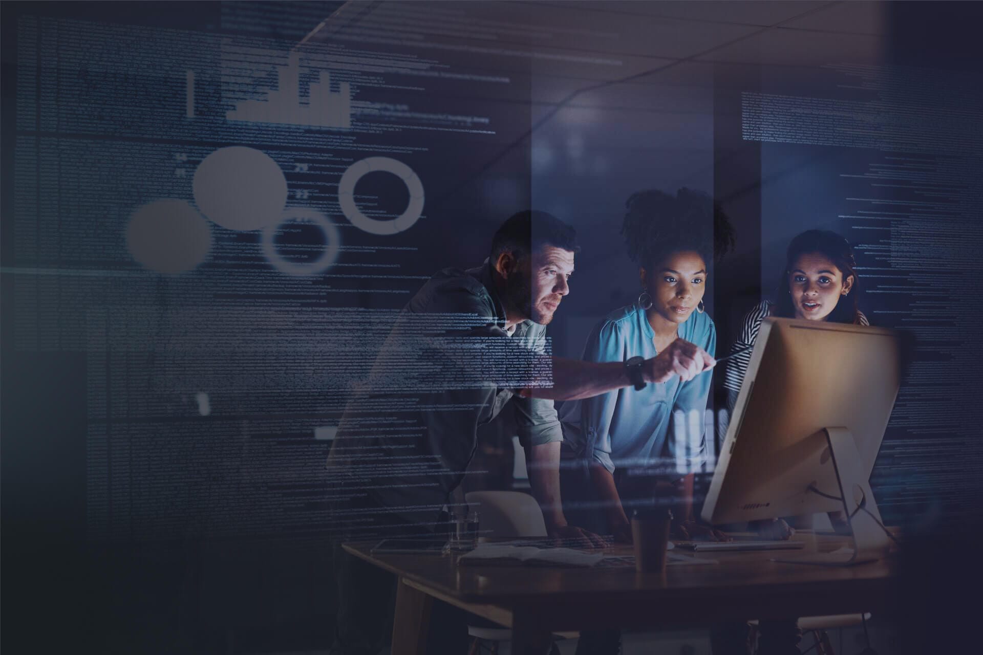 3 People examining data in front of computer