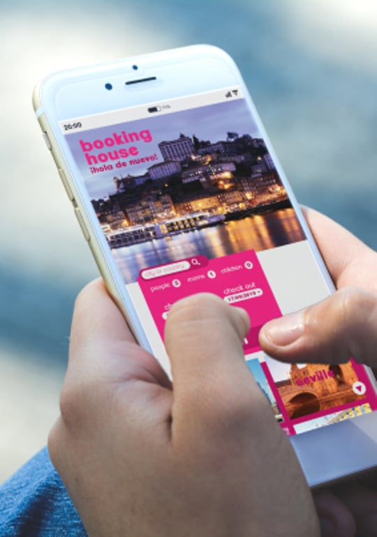Hands typing on iPhone searching for travel booking